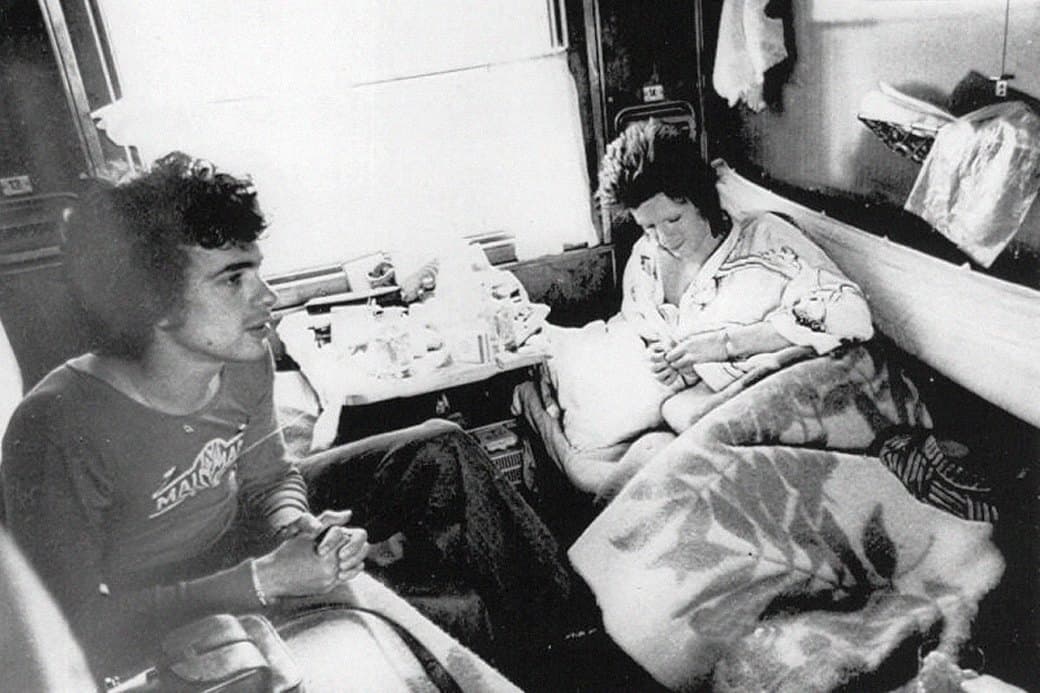 David Bowie on the Trans-Siberian Railway Black and white archival photograph of David Bowie traveling in a sleeper cabin on the Trans-Siberian Railway.